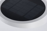 Rundes Solarpanel mit schwarzer Oberfläche und weißem Rahmen für energiesparende Beleuchtung