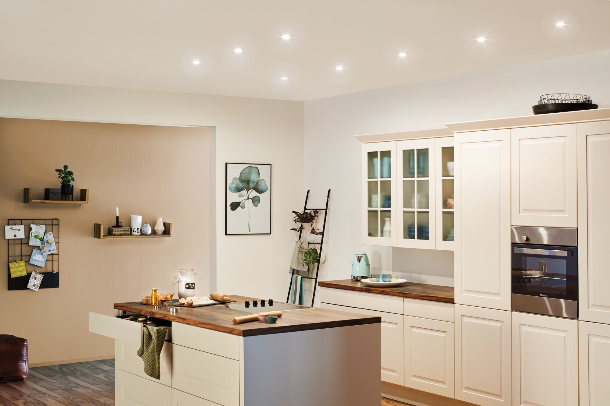 Modern white country kitchen with wooden countertop and integrated stainless steel oven lighting