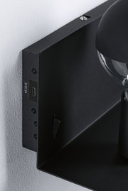 Black metal wall light with visible screws and USB-C port for modern indoor lighting solutions