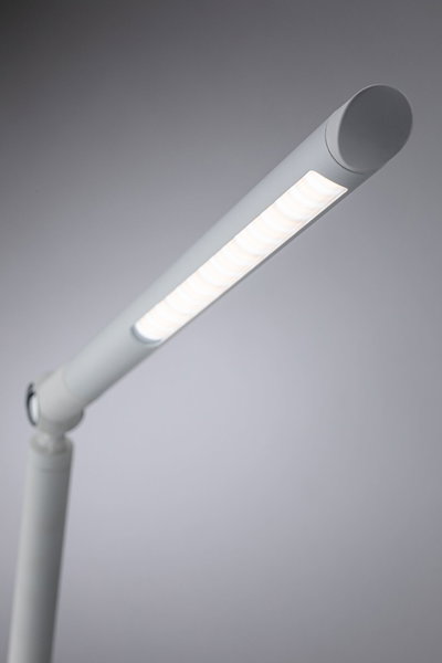 Modern white LED desk lamp with slim design and adjustable arm for efficient lighting in workspaces