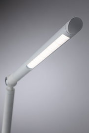 Modern white LED desk lamp with slim design and adjustable arm for efficient lighting in workspaces