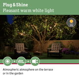 Warm white Plug & Shine LED string lights on garden terrace with comfortable seating