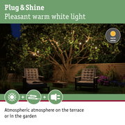 Warm white Plug & Shine LED string lights on garden terrace with comfortable seating