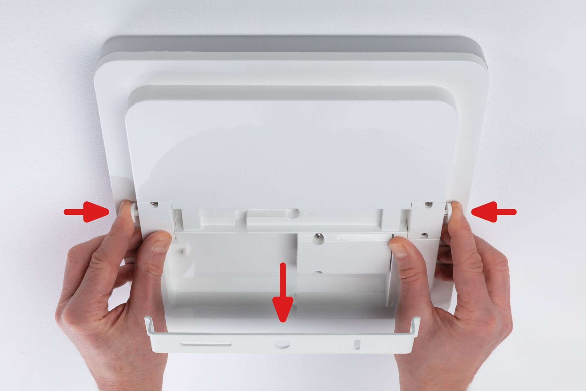 White square plastic ceiling light with mounting guide and hand grips for easy installation