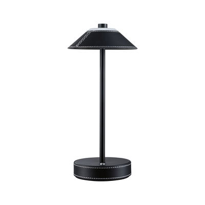 Black table lamp with leather cover and white stitching, modern LED desk lighting design