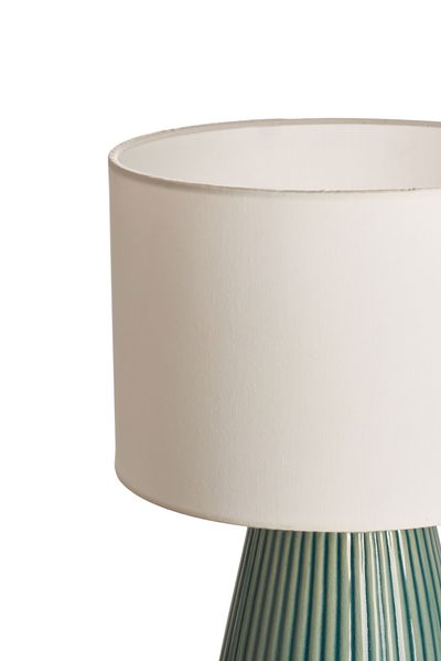 Table lamp with cream fabric shade and ribbed blue-green ceramic base for living spaces