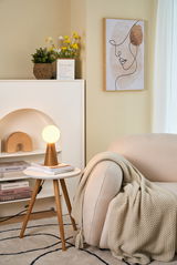 Moderner Holz-Tischleuchte mit rundem opalweißem Glas in gemütlichem Wohnzimmer mit beigem Sofa.