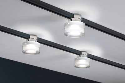 Three round glass LED ceiling spotlights on black rail for modern interior lighting.