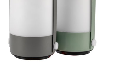 Two modern LED lamps with white glass and grey and green metal bases for indoor lighting