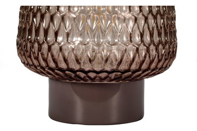Close-up of brown textured glass lampshade with smooth brown metal base for interior lighting.