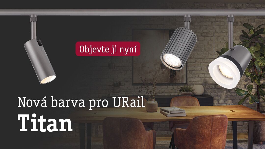Drei titanfarbene URail LED-Strahler aus Metall über einem Holztisch in modernem Esszimmer mit Backsteinwand