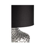 Table lamp with black fabric shade and silver textured metal base for modern interior lighting.