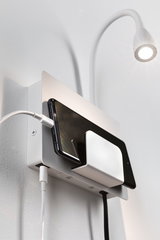 White wall mount with integrated smartphone charging station and flexible LED reading light for modern homes