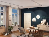 Modern dining room with white glass pendant lights and wooden furniture, stylish LED lighting in living space
