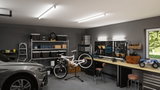 Atelier moderne avec éclairage LED au plafond, établi, support vélo et voiture grise dans le garage.