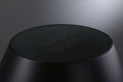 Black round LED light with matte metal housing and textured diffuser for modern indoor lighting