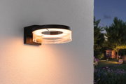 Modern black LED outdoor wall light with round acrylic glass and warm white light for garden lighting