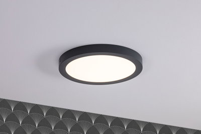 Round LED ceiling light with black metal frame and warm white light for modern living spaces