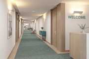 Modern corridor with green carpet runner, wood paneling, and white wall lights for hotel lighting.