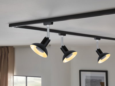 Black metal LED ceiling spotlights with warm white light on track system for living spaces