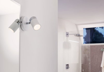 Modern white LED wall spotlight with chrome accents, perfect for bathroom lighting.