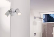 Modern white LED wall spotlight with chrome accents, perfect for bathroom lighting.