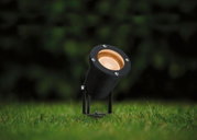 Black metal LED garden spotlight with warm white light, perfect for outdoor garden lighting.