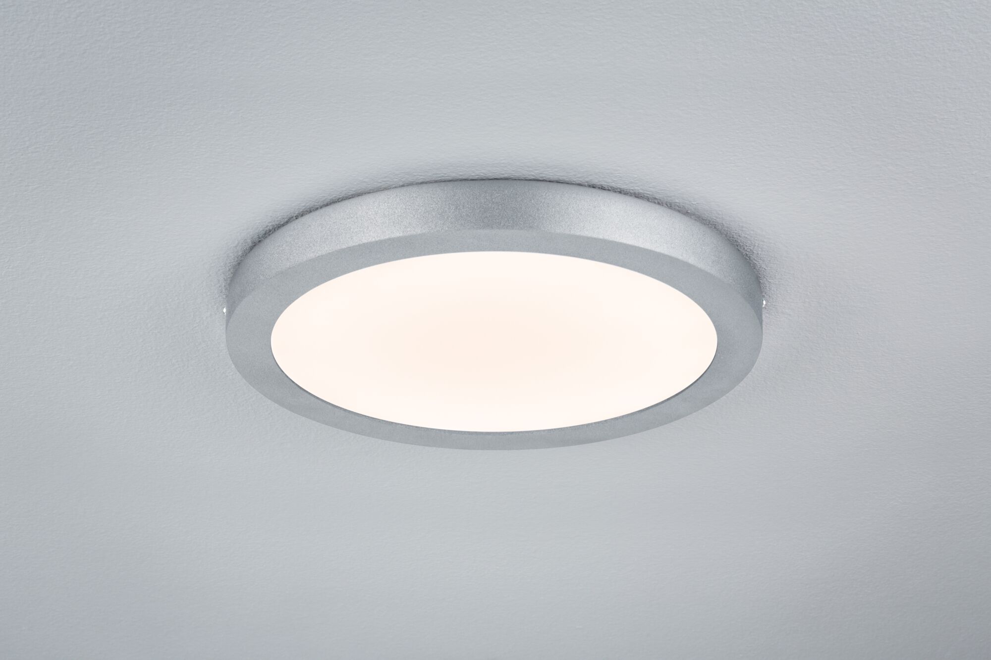 Round LED ceiling light with silver aluminum frame and warm white light for modern interiors