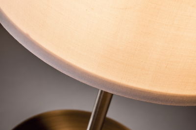 Close-up of beige fabric lampshade with metal frame for home lighting decor