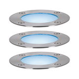 Three round LED recessed floor lights in brushed stainless steel with blue light for outdoor use