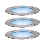 Three round LED recessed floor lights in brushed stainless steel with blue light for outdoor use