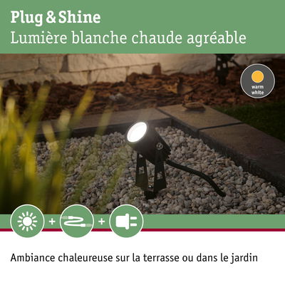 Projecteur extérieur noir avec lumière blanche chaude sur gravier pour terrasse et jardin