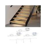 Warm white LED strip lighting under wooden stairs with connectors for indirect stair illumination