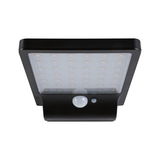 Black LED outdoor wall light with motion sensor and diffused cover for energy-efficient lighting