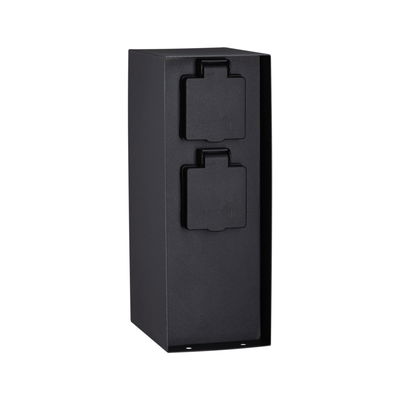 Black outdoor metal socket with two protective covers for weatherproof garden power supply.