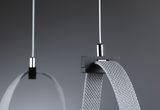 Close-up of grey textile strap with black plastic holder and white cable for lighting system.