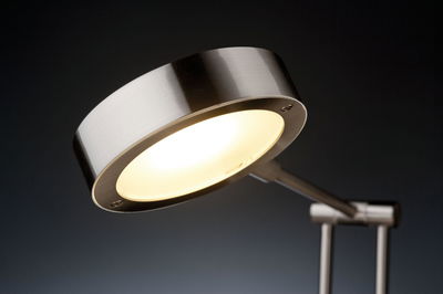 Modern LED desk lamp with brushed silver metal for focused lighting in workspaces and offices