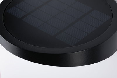 Black round solar panel with textured surface made of durable material for sustainable energy use.