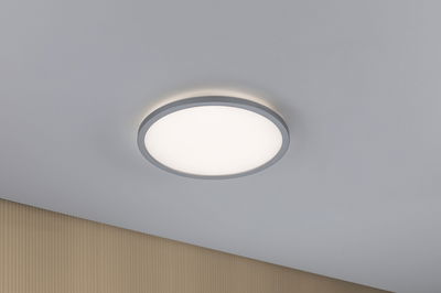 Round LED ceiling light with silver aluminum frame and warm white light for modern interiors