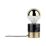 Modern table lamp with gold bulb, black marble, and brass base for stylish lighting decor