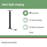 Black LED floor lamp with round light head and cable connection for indoor lighting