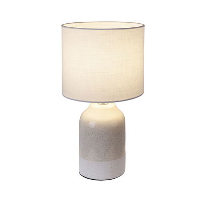 Table lamp with cream ceramic base and light fabric shade for cozy home lighting