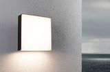 Square outdoor wall light with white diffuser and black frame for modern exterior lighting