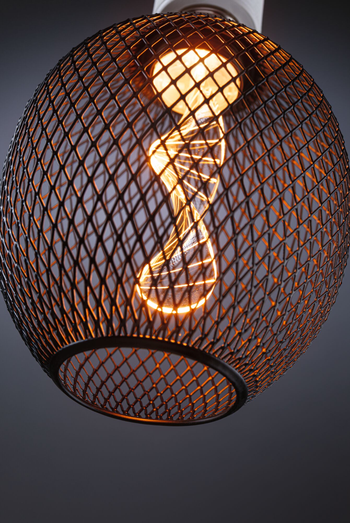 Round metal lamp with black mesh and warm white LED bulb for modern indoor lighting design
