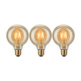 Drei runde LED-Glühbirnen mit warmweißem Licht und bernsteinfarbenem Glas für dekorative Beleuchtung.