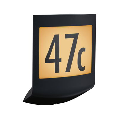 Black illuminated house number sign with yellow background showing number 47c for outdoor lighting