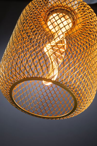 Gold metal mesh lampshade with visible LED bulb for modern home lighting and decorative effect