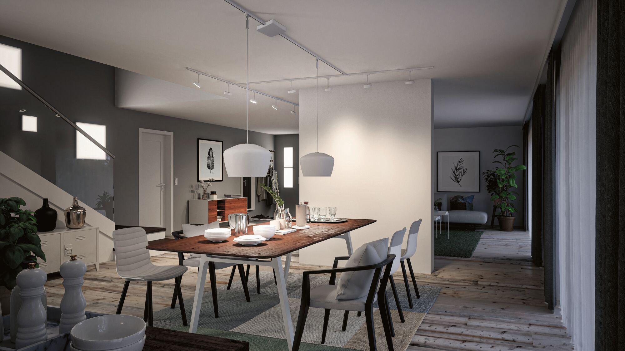 Modern dining area with wooden table, white chairs and two white pendant lights in bright room