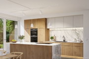 Modern kitchen with wood fronts, white marble surfaces, and white pendant lights for stylish lighting
