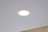 Round LED recessed light with warm white glow in white ceiling for modern room lighting